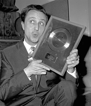 Ken Dodd with his golden disc for 100, 000 copies of his record sold "Tears" presented to him in his dressing room at the London Palladium.